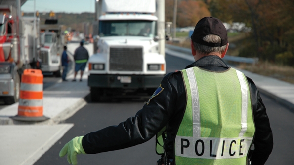 police officer stopping a cargo truck