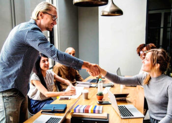 man-and-woman-shaking-hands-in-meeting