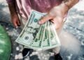 man-holding-us-dollars-hands