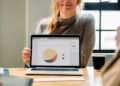 woman-showing-presentation-pie-chart